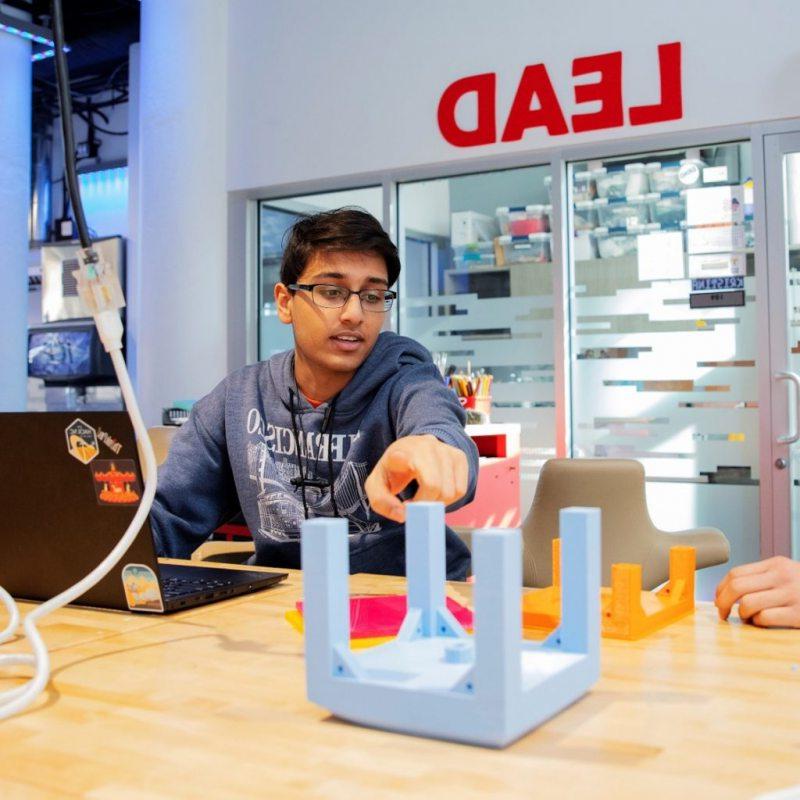 QUVI founders Kush Jain (right) and Harshul Makwana (left) working on their initial water bottle sanitation prototype for the UNC Makeathon.